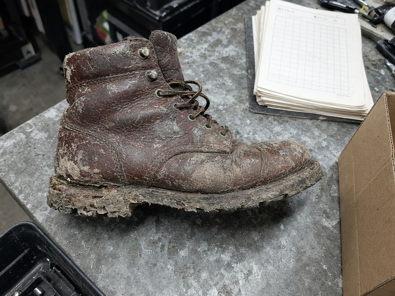 Work boot, before: cracked, dried-out leather and a worn, crumbling sole